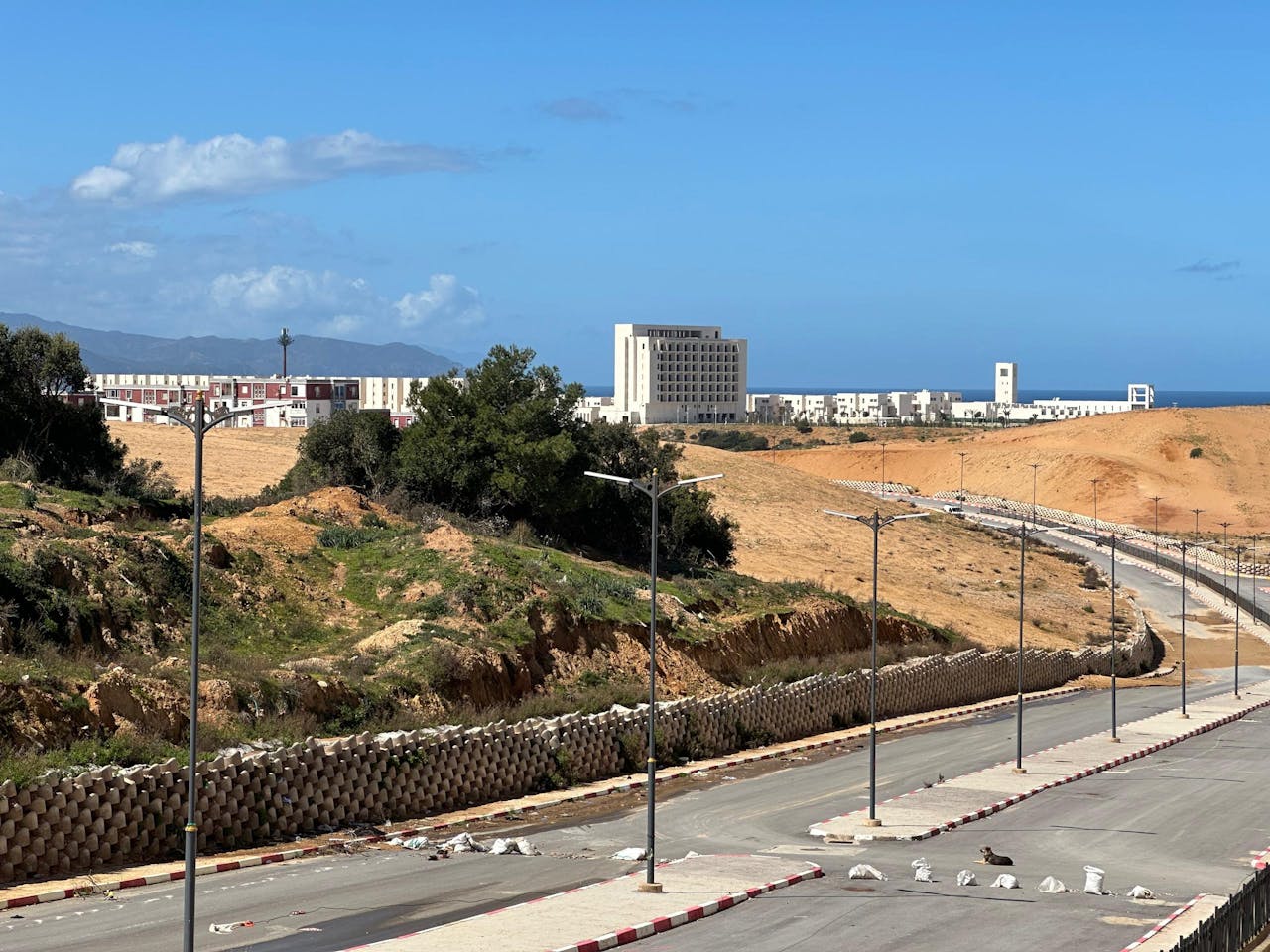 A scenic view of Skikda's landscape with buildings and clear sky.