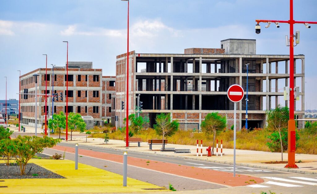 Outdoor scene of modern unfinished buildings under a cloudy sky.